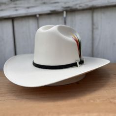 El precio INCLUYE impuestos y ENVIO a cualquier parte de los Estados Unidos! Este es el 1000X Chaparral, un sombrero vaquero distinguido de Tombstone Hats, diseñado tanto para el estilo como para la accesibilidad. Cuenta con un ala de 3 1/2" y una copa de 4 1/2", elaborado con el exquisito material Telar Master 1x1, asegurando durabilidad y comodidad. Orgullosamente hecho en México, esta variante luce una llamativa toquilla para el sombrero en negro y está elegantemente adornado con una pluma pa White Western Fedora Panama Hat, White Western Style Panama Hat, White Western Panama Hat With Curved Brim, White Western Style Panama Hat For Outdoor, White Western Panama Hat With Short Brim, White Straw Hat For Ranch, White Brimmed Panama Hat For Rodeo, Western White Panama Hat For Kentucky Derby, White Short Brim Panama Hat For Ranch