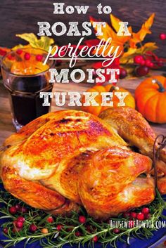 a roasted turkey on a blue plate with berries and oranges in the background text reads how to roast a perfectly moist turkey