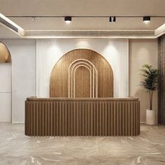 an empty reception room with a large wooden counter in front of a white wall and two potted plants