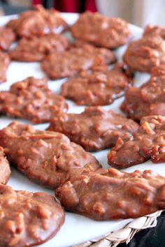 chocolate cookies are on a white plate and ready to be eaten