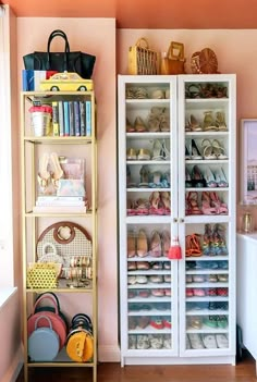 a closet filled with lots of shoes next to a white cabinet in a living room