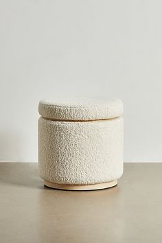 a white round container sitting on top of a table