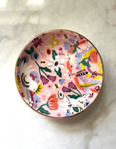 a colorful bowl sitting on top of a white counter