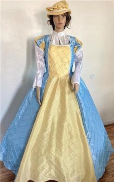 This listing is for a one piece Elizabethan, Renaissance, Medieval, Romeo & Juliet dress/gown and hat, your custom size choice of busts 30" to 44". The dress is made of a mix of light blue and yellow pintuck taffeta with the lower straight sleeves being made of white taffeta.  There is white gimp trim throughout.  And the flat hat is made of matching yellow pintuck taffeta with the same trim and a small brim.  The  bodice and upper sleeves are fully lined, and the dress laces down the back with Royal Blue Royal Dresses For Costume Party, Royal Long Sleeve Costume Dresses, Royal Blue Costume Dress, Fitted Royal Blue Dress For Costume, Blue Victorian Dress With Fitted Bodice Ball Gown, Blue Victorian Dress With Fitted Bodice, Fitted Blue Victorian Dress For Fancy Dress Events, Blue Victorian Ball Gown With Fitted Bodice, Royal Gown For Costume Event