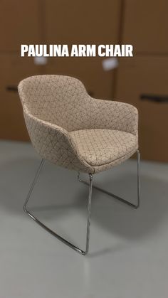 a white chair sitting on top of a gray floor next to a brown box with drawers