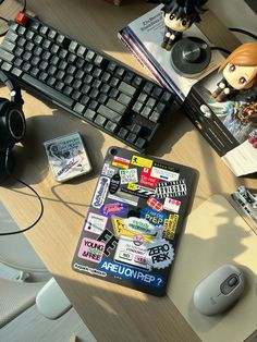 a computer keyboard sitting on top of a desk next to a mouse and headphones