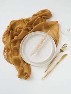 a table setting with goldware and a napkin