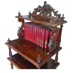 an antique wooden book shelf with red books on it's top and bottom shelves