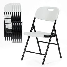 a stack of white and black folding chairs next to each other