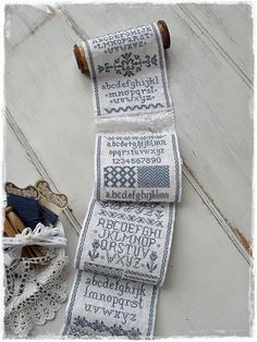 three rolls of cross - stitch on top of each other