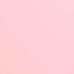 an airplane is flying in the sky on a pink background