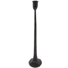 a tall black candle holder on a white background