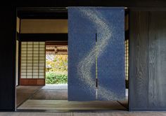 an open door in a room with wood paneling and blue paint on the walls