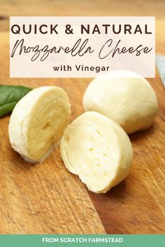 two peeled mozzarella cheeses on a wooden cutting board with basil leaves in the background