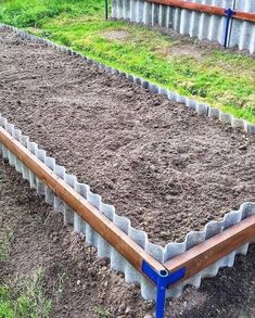 several rows of raised garden beds filled with dirt