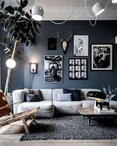 a living room filled with furniture and pictures on the wall