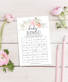 a baby shower game with pink flowers and pencils on the table next to it