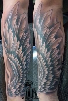 the legs are covered with white wings on this man's leg, while he is wearing