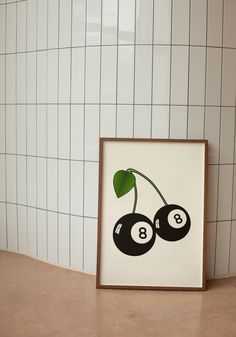 a framed print with two black cherries on it