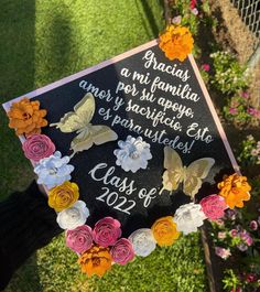 a graduation cap decorated with flowers and butterflies