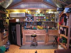 the inside of a garage with lots of shelves and tools on it's walls