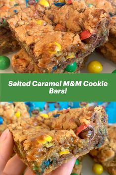 a hand holding up a piece of m & m cookie bars with m & m candies on top