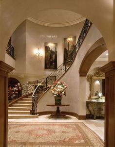 a large foyer with a staircase leading up to the second floor