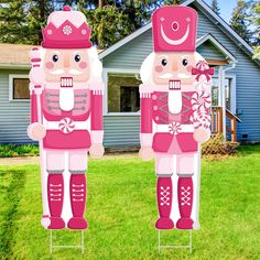 two large inflatable nutcrackers standing on top of each other near a house