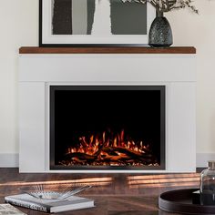 a fire place in a living room next to a vase with flowers on the table