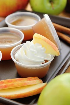 apples and cream in small cups on a tray