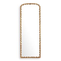 an ornate gold framed mirror on a white wall