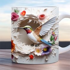 a coffee mug with a bird and flowers on the inside is sitting on a table