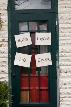 the front door of a building with signs taped to it