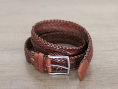 "Handmade by us from thick hand weaving, design and care. The brandy colour leather is vegetable tanned, it will shine and flourish as it is used. *If you want, I can remove the brand (logo) on the front, just send a message *An elegant belt to be used for many years *It can be used for either men or women. *No holes, can be installed anywhere. *All Belt buckles color is smoked black. SİZE : Width of the belt 1.3 inch/ 3.4cm IMPORTANT! It is the size of the BELT, not your waist or pant. size you Casual Braided Leather Belt, Vintage Brown Belt As A Gift, Vintage Brown Belt For Gift, Vintage Brown Belt As Gift, Brown Woven Leather Belt, Adjustable Woven Leather Belt, Casual Brown Woven Leather Belt, Handmade Brown Belt For Everyday Use, Handmade Brown Belts