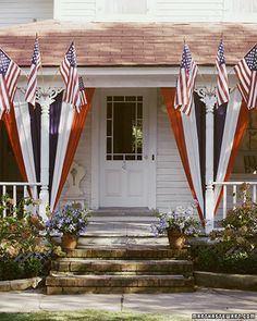 the american flags are on display in front of the house