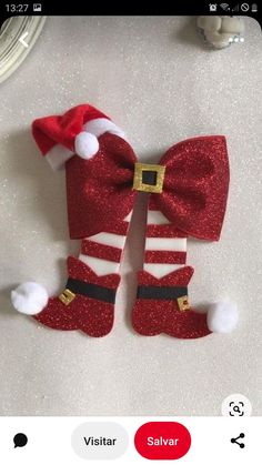 a pair of red and white christmas socks with santa's hat on them