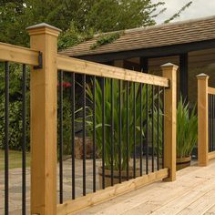 an image of a wooden deck with wrought iron railings on the front and side