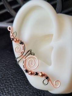 the ear is adorned with wire and beads