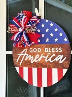 a patriotic sign with the words godbles america on it, hanging from a door