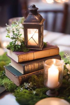 two books stacked on top of each other with a lit candle in front of them