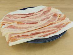 two slices of bacon sit on a plate