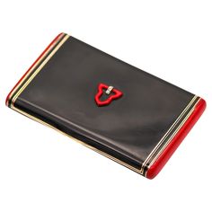 a black and red business card case with a heart shaped key on the front side