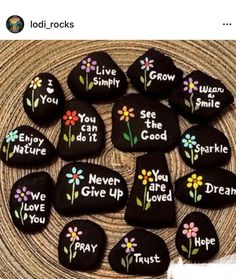 some rocks with flowers painted on them and the words you are loved written on them