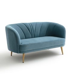 a blue couch sitting on top of a white floor