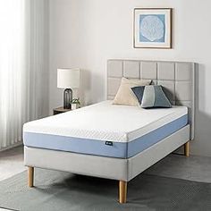 an image of a mattress in the middle of a room with white walls and curtains