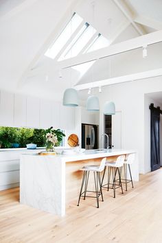 an open kitchen with white walls and wooden floors is featured in the instagram post