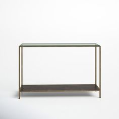 a glass and metal table with shelf on the bottom, in front of a white background