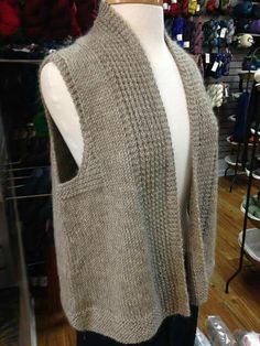 a mannequin wearing a sweater in a store