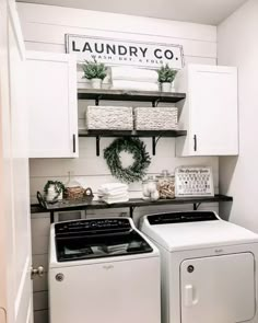 a white washer and dryer sitting next to each other in a laundry room