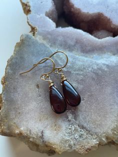 Such a unique and gorgeous stone! Bright glowly garnet hangs from gold filled or sterling silver ear wires 30mm drop Gold Garnet Teardrop Earrings, Gold Teardrop Garnet Earrings, Amber Teardrop Birthstone Jewelry, Handmade Amber Teardrop Earrings, Sterling Silver Teardrop Pendant Jewelry With Ear Wire, Sterling Silver Teardrop Pendant With Ear Wire, Garnet Drop Earrings With Ear Wire, Nickel-free Garnet Drop Earrings, Garnet Drop Earrings With Matching Set